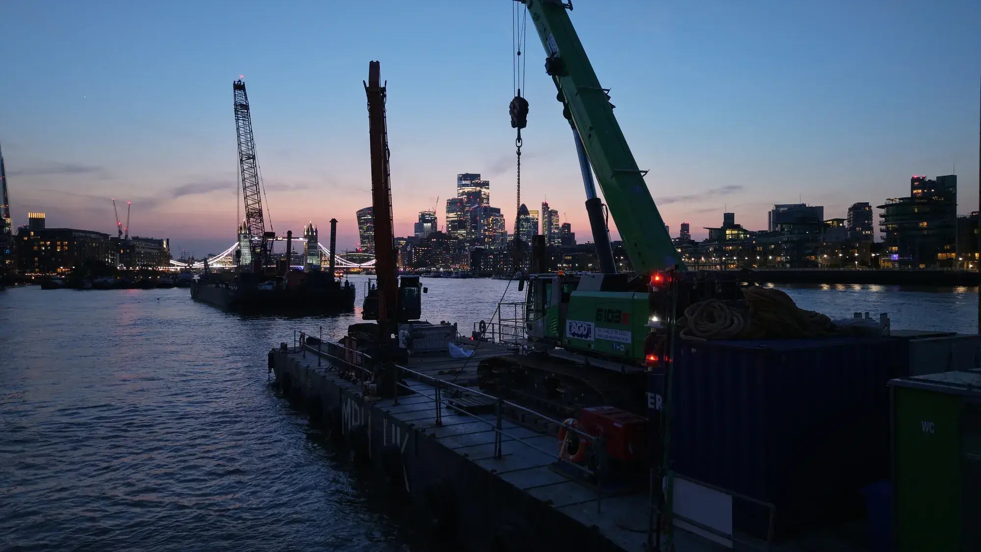 MPH UK spud-leg pontoon jacked up on the River Thames at twilight — aerial drone photograph