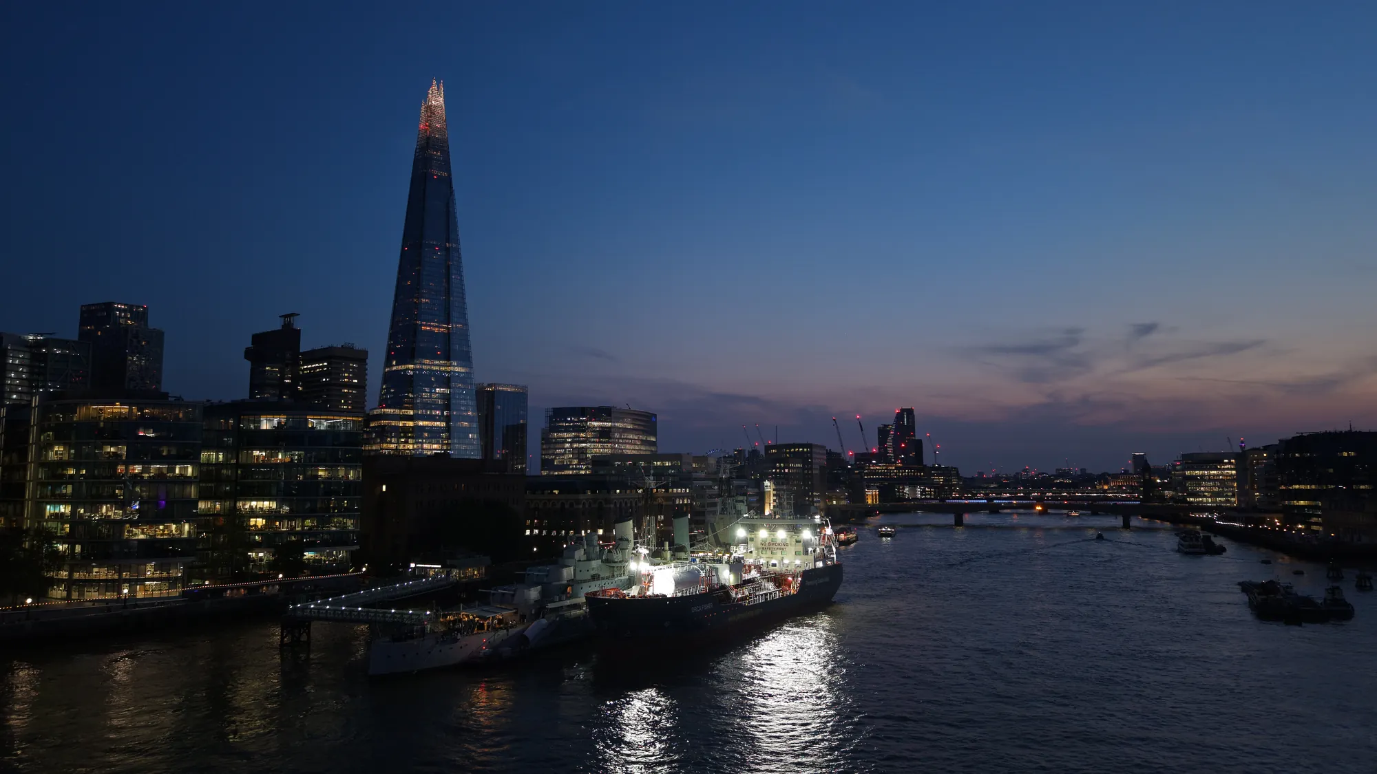 Aerial view of the City of London skyline at night with The Shard and illuminated buildings across the capital