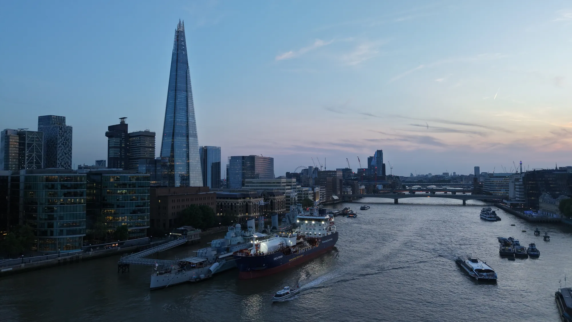 Aerial riverside view over the River Thames by HMS Belfast and London Bridge used for site mapping