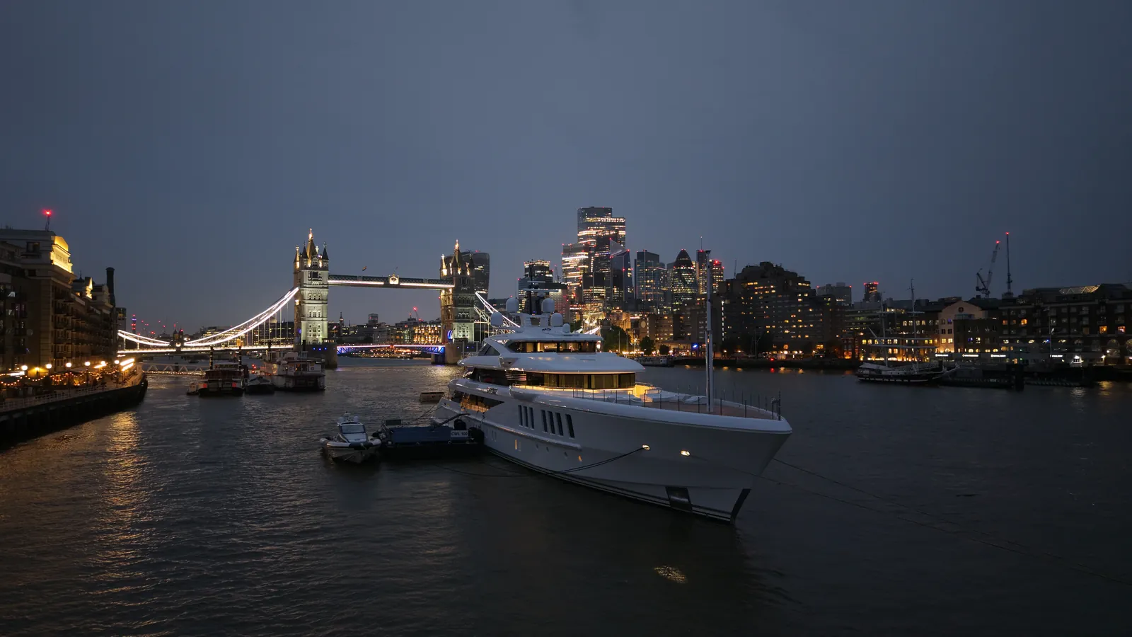 Twilight aerial photograph of superyacht Spectre moored near Tower Bridge in London, captured by UAS London