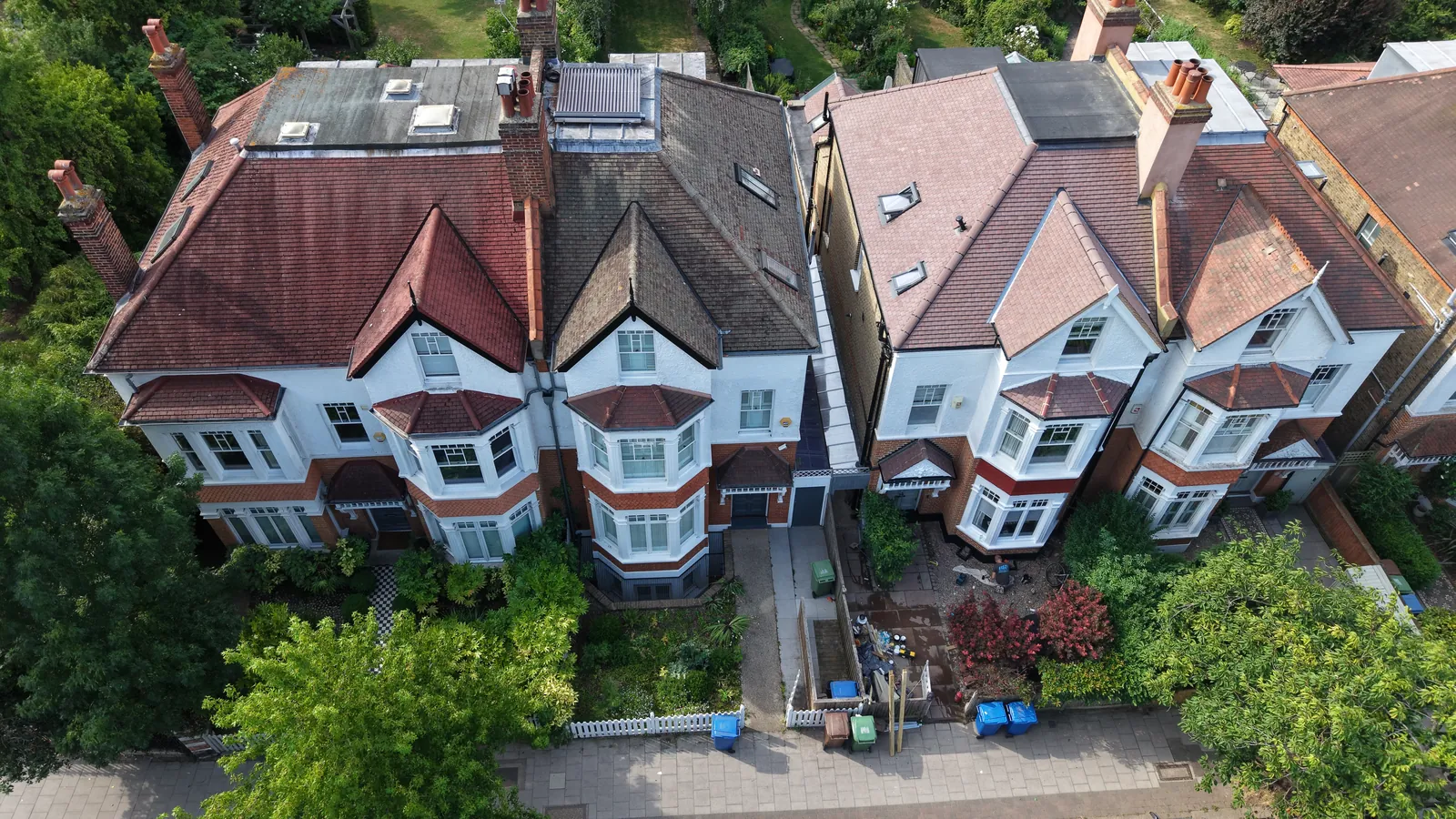 Elevated aerial photograph of Victorian houses on a tree-lined London street for property marketing