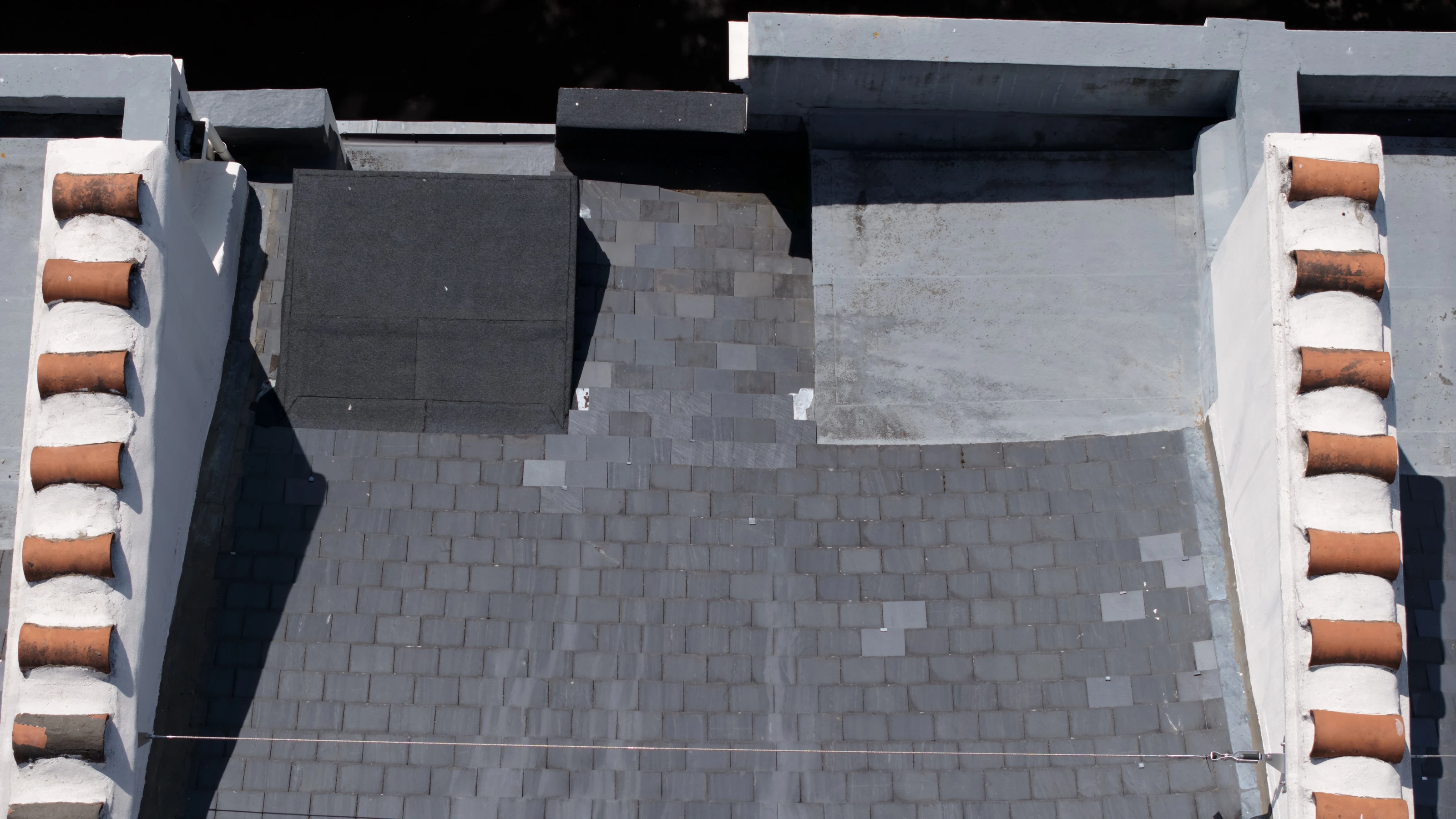 Drone survey detail of a parapet, lead flat roof and the junction where it meets the slate pitch.