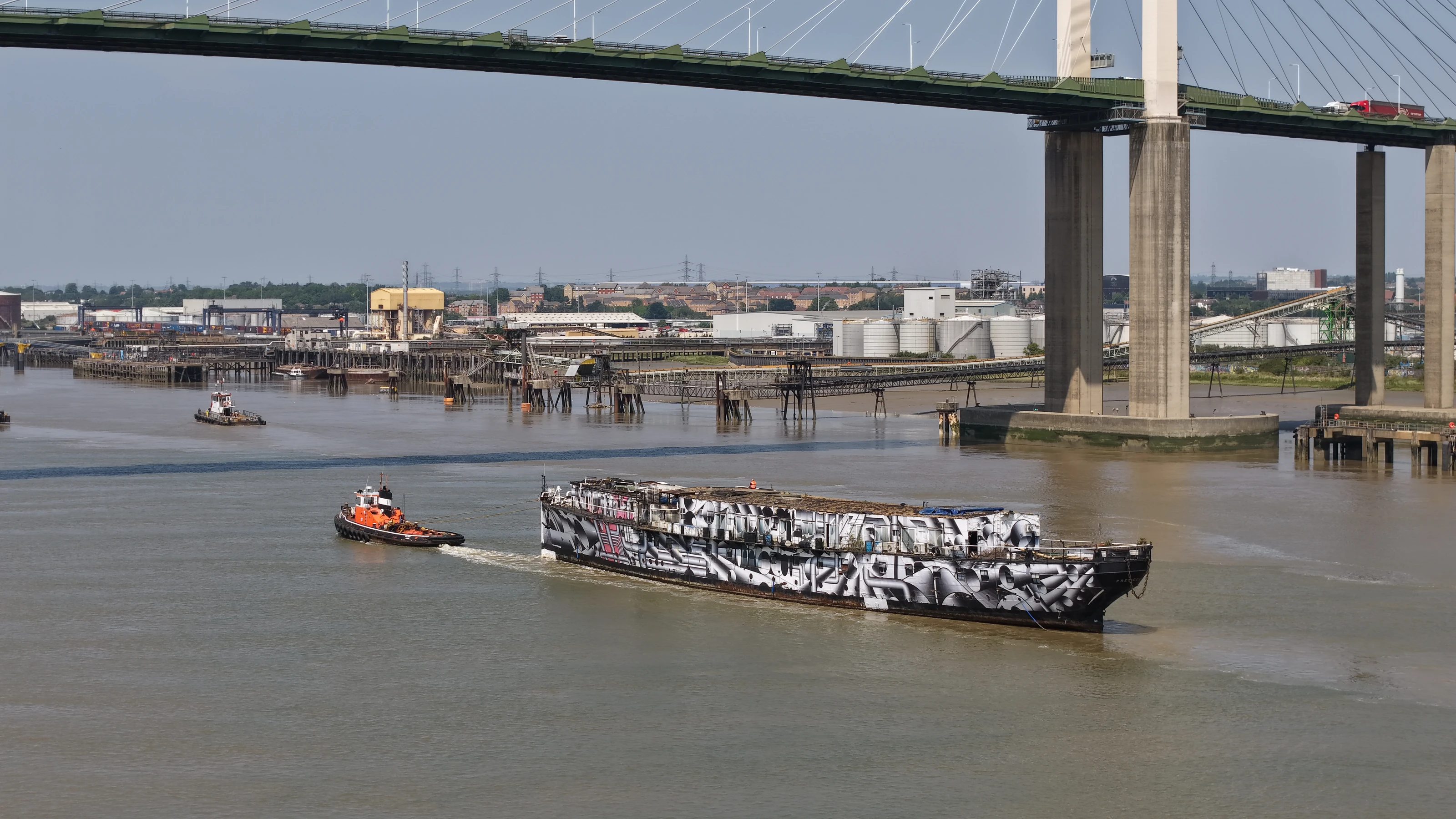 HMS President (1918) under tow passing beneath the Queen Elizabeth II Bridge at the Dartford Crossing