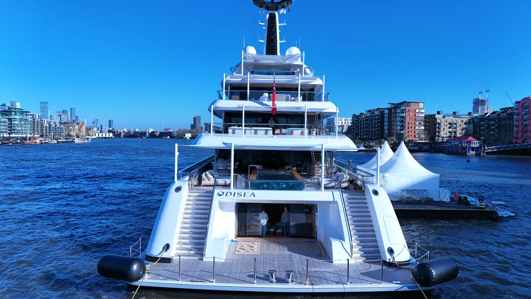 Aerial photograph of the superyacht Odisea alongside on the River Thames at Tower Bridge.