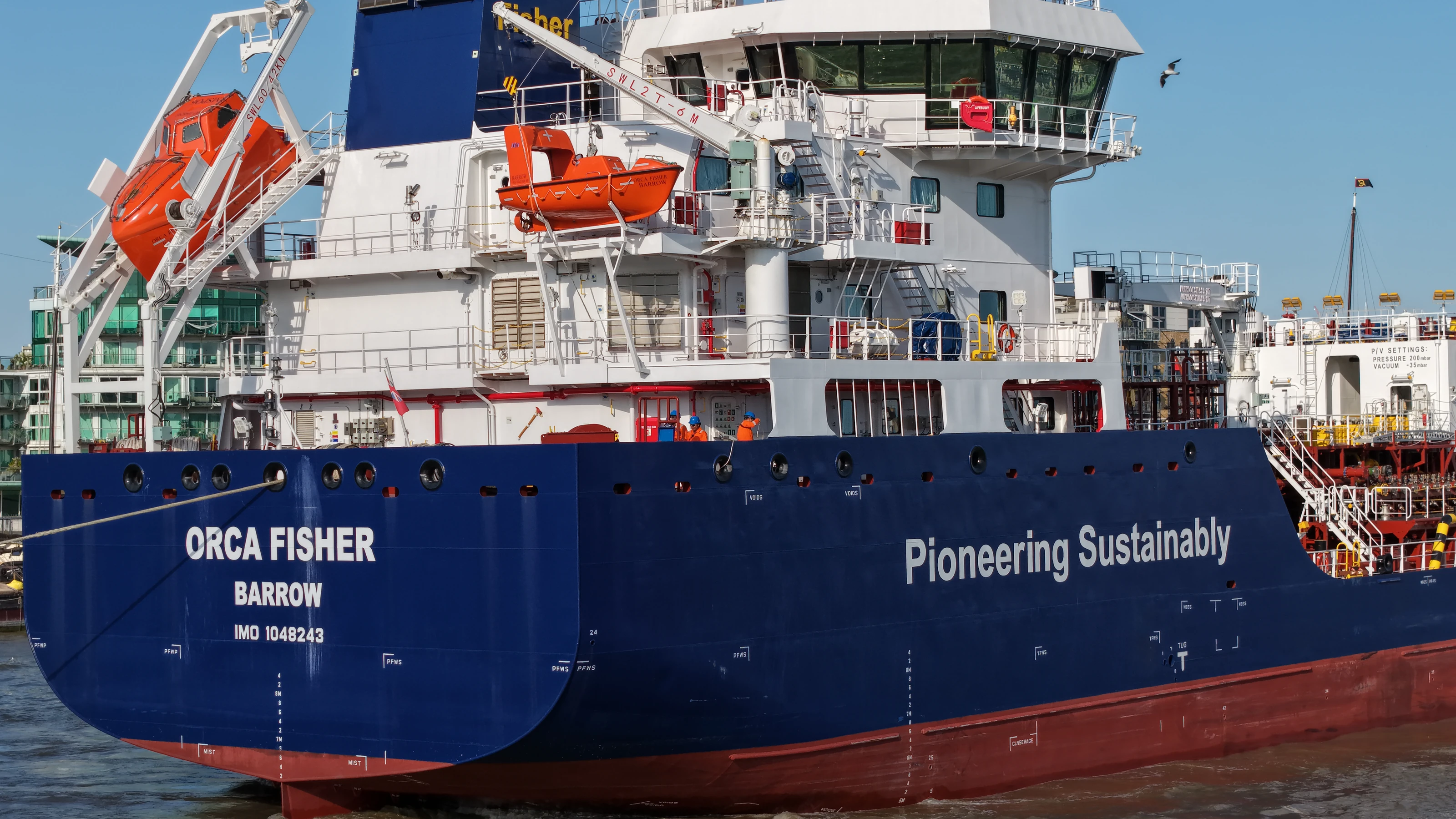 The James Fisher tanker Orca Fisher of Barrow under way on the River Thames, crew on deck forward of the accommodation