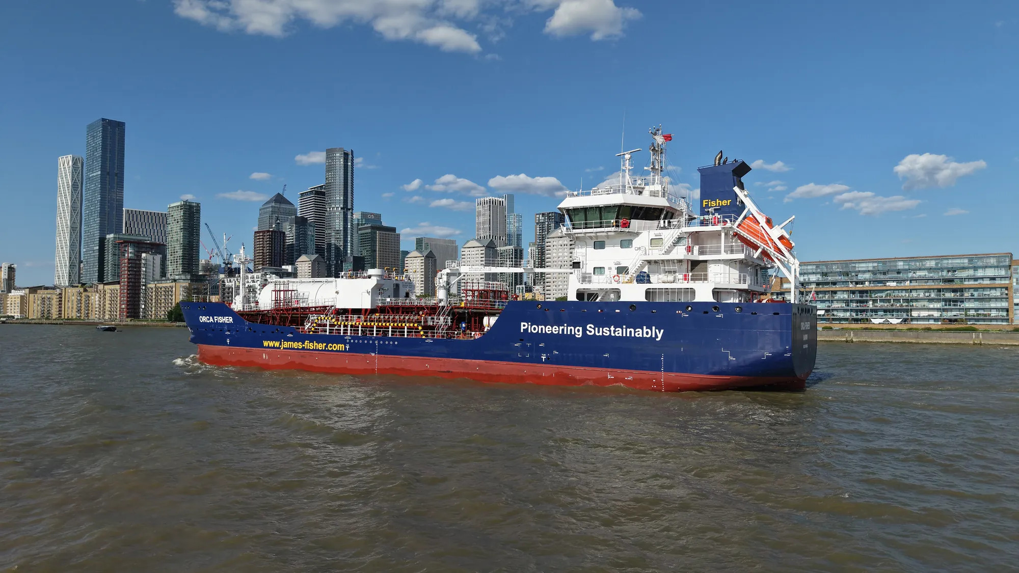 James Fisher tanker Orca Fisher transiting the River Thames past the Canary Wharf skyline