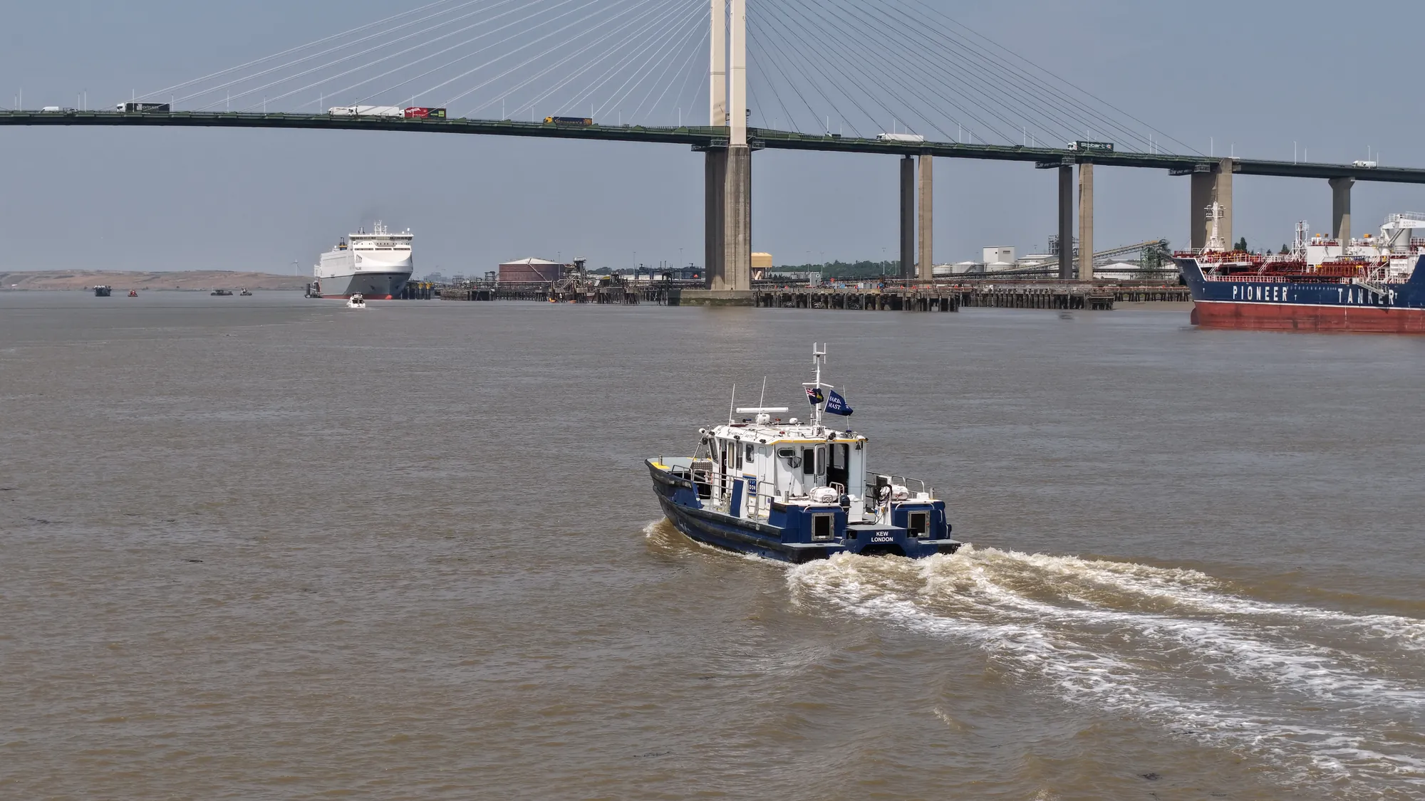 PLA harbour service launch Kew underway on the tidal River Thames at the Dartford Crossing.