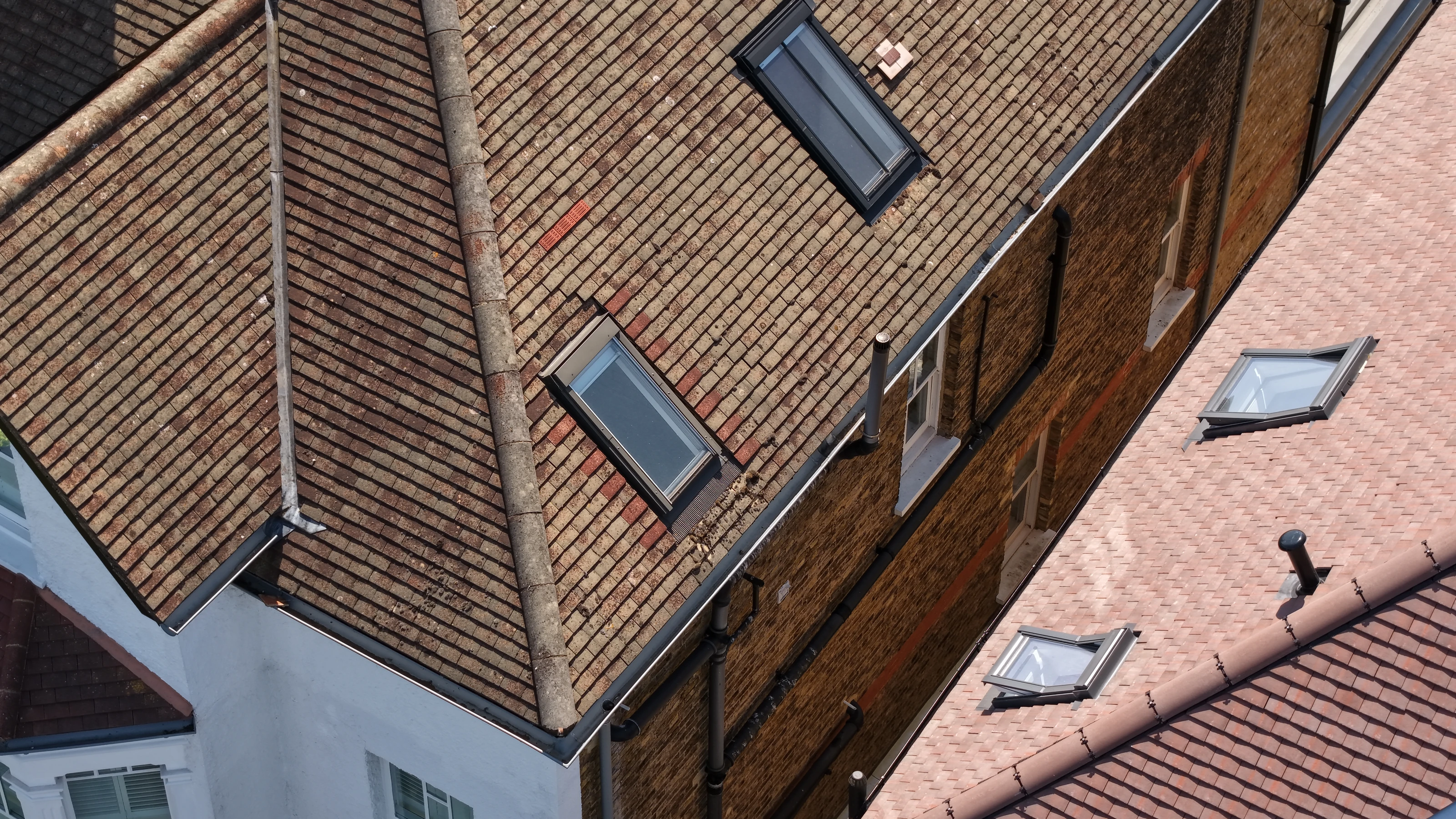 Drone survey detail of a domestic roof, showing rooflights, a valley gutter and the junction with the neighbouring pitch.